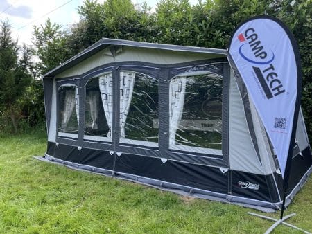 A tent with a white and black awning