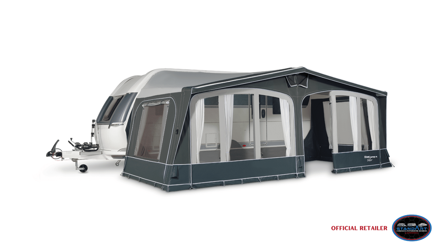 A caravan with a large awning and a small trailer.