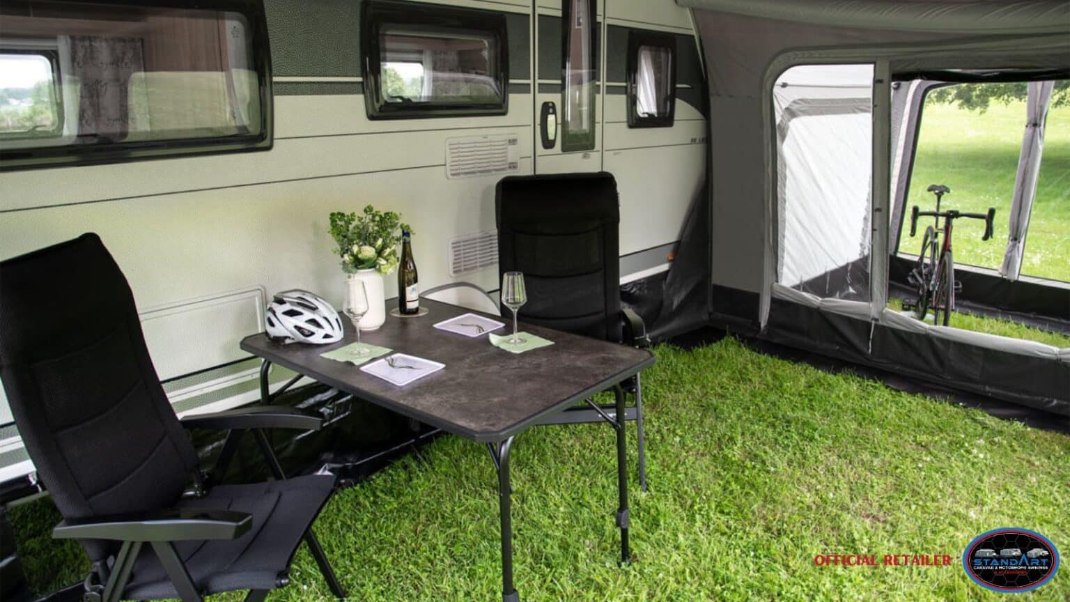 A room with green carpet and black furniture.