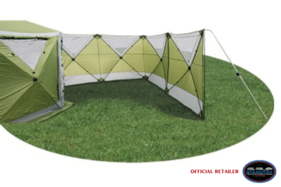 Green outdoor tent with extended wall panel.
