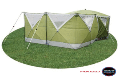 Green tent on grass with reflective covering.